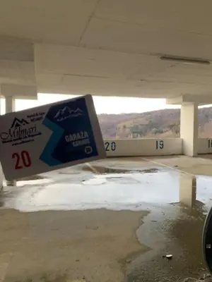 a ramp in a parking garage with snow on the ground at Apartman Leki in Kopaonik