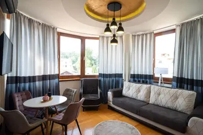 a living room with a couch and a table at Promenada Grujić in Vrnjačka Banja