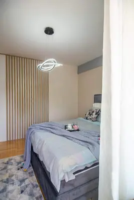 a bedroom with a bed and a ceiling at Promenada Grujić in Vrnjačka Banja