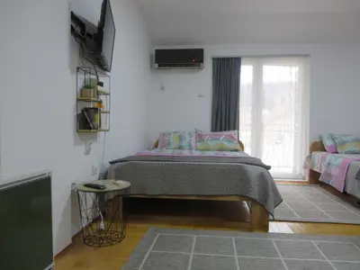a bedroom with a bed and a window at Studio Centar Park in Soko Banja