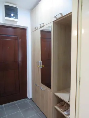a closet with a wooden door and a mirror at Studio Centar Park in Soko Banja