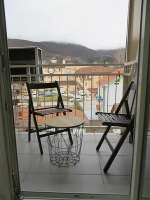 two chairs and a table on a balcony at Studio Centar Park in Soko Banja