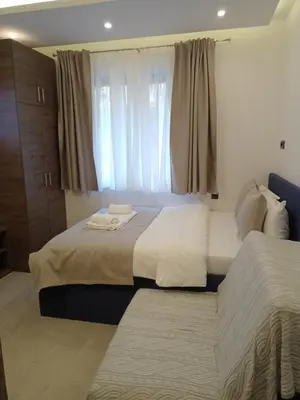 a bedroom with two beds and a window at Milmari N Lux 52 in Kopaonik