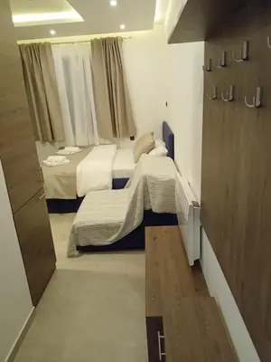a small bedroom with two beds and a sliding door at Milmari N Lux 52 in Kopaonik