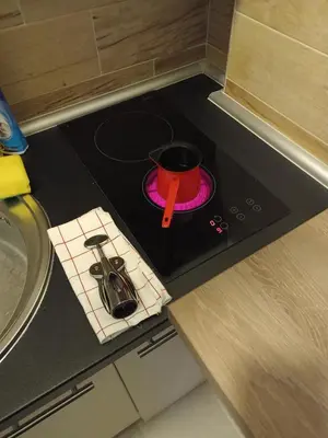 a stove top with a pot on top of it at Milmari N Lux 52 in Kopaonik