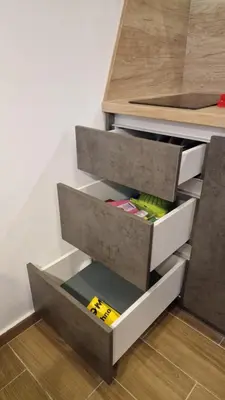 an open drawer in a kitchen with a counter at Xenia Apartment in Kopaonik