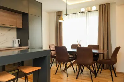 a kitchen and dining room with a table and chairs at Vila Golija in Kopaonik