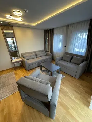 a living room with two couches and a table at Vila Golija in Kopaonik
