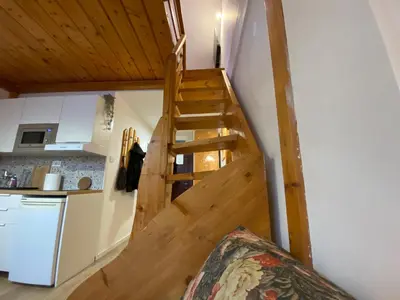 a staircase in a tiny house with a kitchen at Bele Staze Apartman 86 in Brzeće
