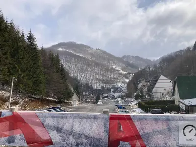 a view of a town with a snow covered mountain at Bele Staze Apartman 86 in Brzeće