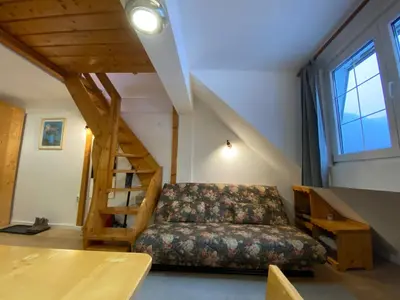 a living room with a couch and a staircase at Bele Staze Apartman 86 in Brzeće