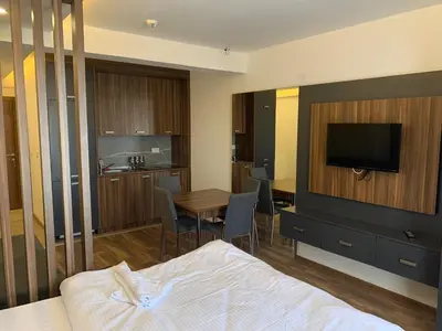 a hotel room with a bed and a table and a television at President Kop S2 in Kopaonik