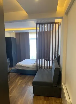 a bedroom with a crib with a bed in it at President Kop S2 in Kopaonik
