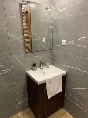 a bathroom with a sink and a mirror at President Kop S2 in Kopaonik