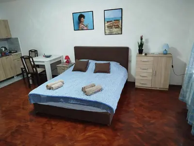 a bedroom with a bed with two towels on it at Bagdala 2 in Kruševac