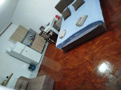 an overhead view of a bedroom with a bed and wooden floors at Bagdala 2 in Kruševac