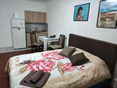 a bedroom with a bed with a flower pattern on it at Bagdala 2 in Kruševac