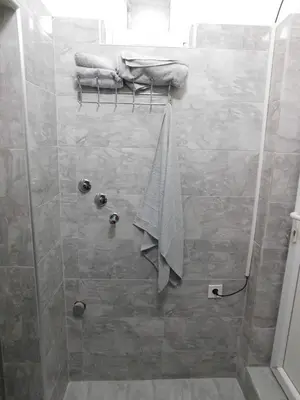 a bathroom with a shower with a towel on a rack at Bagdala 2 in Kruševac