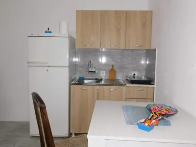 a kitchen with a white refrigerator and a table at Bagdala 2 in Kruševac