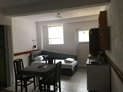 a small room with a table and a bed at VILA ZORICA in Ribarska Banja