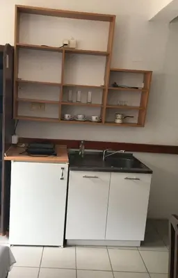 a kitchen with white cabinets and a sink at VILA ZORICA in Ribarska Banja