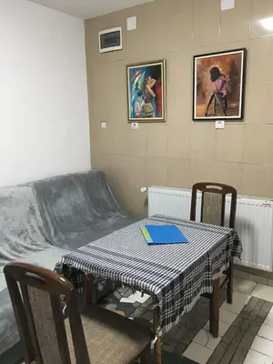 a room with a bed and a table and chairs at VILA ZORICA in Ribarska Banja