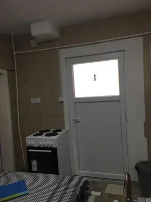 a door leading to a kitchen with a stove at VILA ZORICA in Ribarska Banja