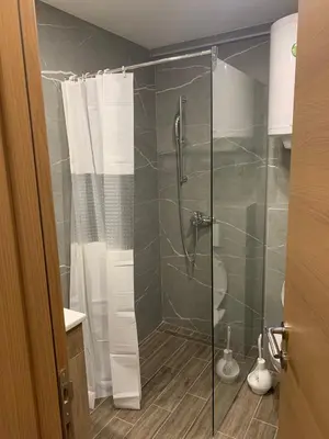 a bathroom with a shower with a glass door at President Kop A 735 in Kopaonik
