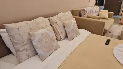 a bed with four pillows on top of it at Magic Kop - Milmari Resort in Kopaonik