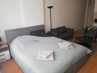 a bedroom with a bed with two towels on it at City Center Studio in Niš