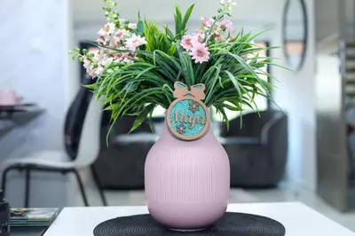 a pink vase with flowers in it on a table at Maja Lux Apartman Brzece in Brzeće