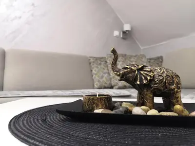 a statue of an elephant on a table in a room at Maja Lux Apartman Brzece in Brzeće