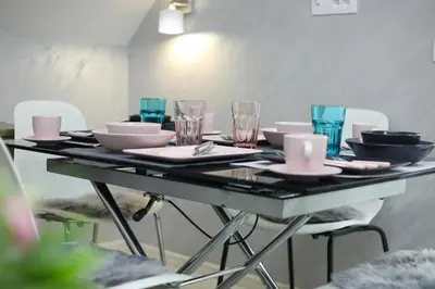 a table with plates and bowls and glasses on it at Maja Lux Apartman Brzece in Brzeće