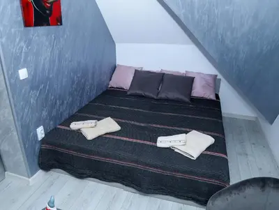 a bed in a room with two pillows on it at Maja Lux Apartman Brzece in Brzeće