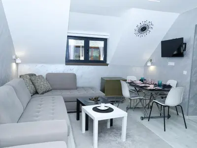 a living room with a couch and a table at Maja Lux Apartman Brzece in Brzeće