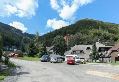 a village with cars parked on the side of a road at Maja Lux Apartman Brzece in Brzeće