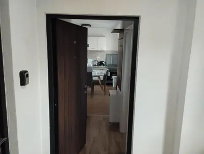 a door leading into a kitchen with a kitchen at Apartman Iznad Oblaka in Kopaonik