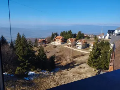 an aerial view of a house with trees on a hill at Apartman Iznad Oblaka in Kopaonik