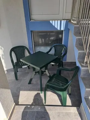 two chairs and a green table and a table and chairs at Relja in Soko Banja