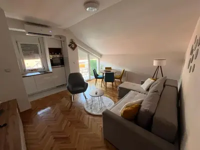 a living room with a couch and a table at MD apartman Vranje FREE PARKING in Vranje