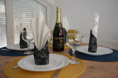 a table with two plates and a bottle of wine at MD apartman Vranje FREE PARKING in Vranje
