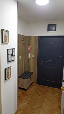 a room with a door with a bench in front of it at MD apartman Vranje FREE PARKING in Vranje