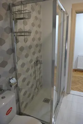 a shower stall in a bathroom with a toilet at MD apartman Vranje FREE PARKING in Vranje