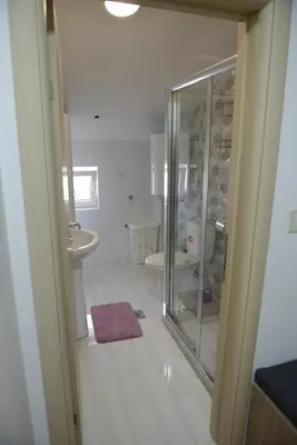 a bathroom with a glass shower and a sink at MD apartman Vranje FREE PARKING in Vranje