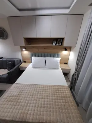a large white bed in a room with a couch at Lux apartmani Dunja Kopaonik Čardaci - GREEN in Kopaonik