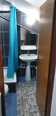 a bathroom with a sink and a toilet and a tub at City center apartment 3 in Niš