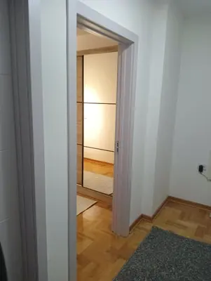 an open door to a room with a mirror at Welcome Apartments in Niš