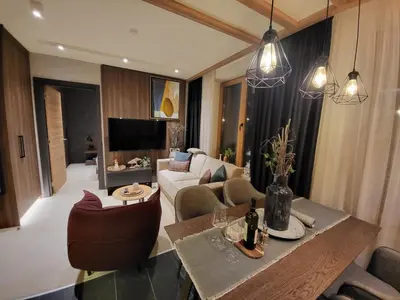 a living room with a couch and a table at Woodside 430 Apartment in Kopaonik