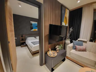 a bedroom with a bed and a couch and a mirror at Woodside 430 Apartment in Kopaonik
