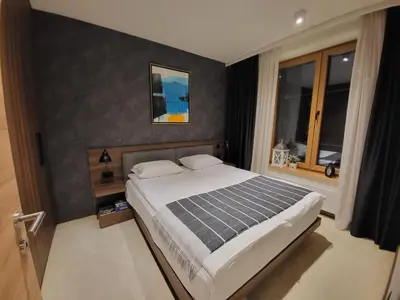 a bedroom with a large bed and a window at Woodside 430 Apartment in Kopaonik